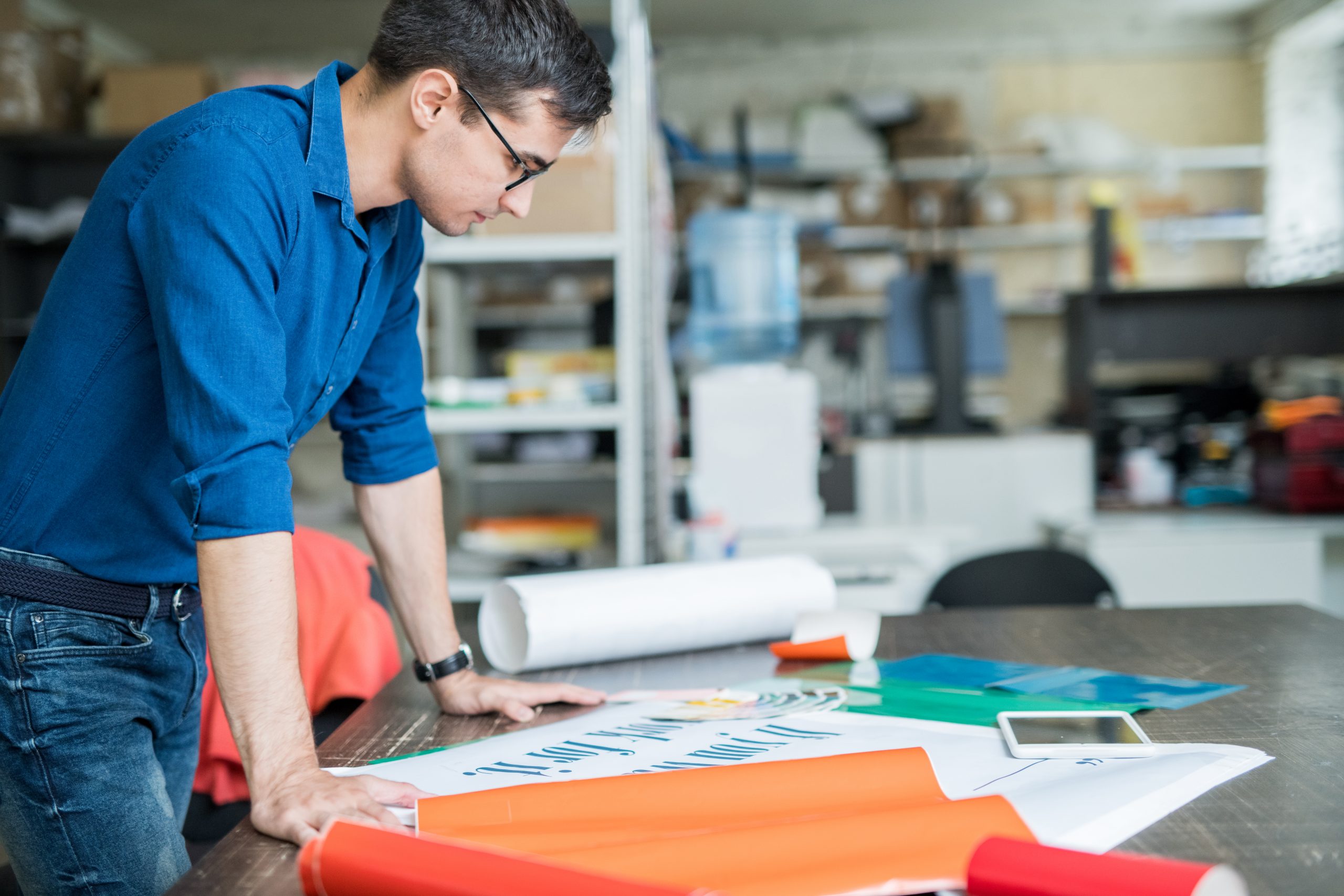 Concentrated designer thinking about paper for printing
